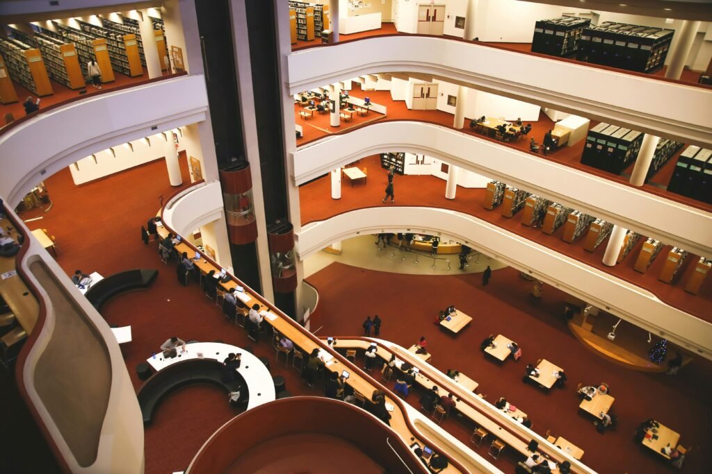 Aerial view of a multistory library interior with people studying at tables in Toronto.